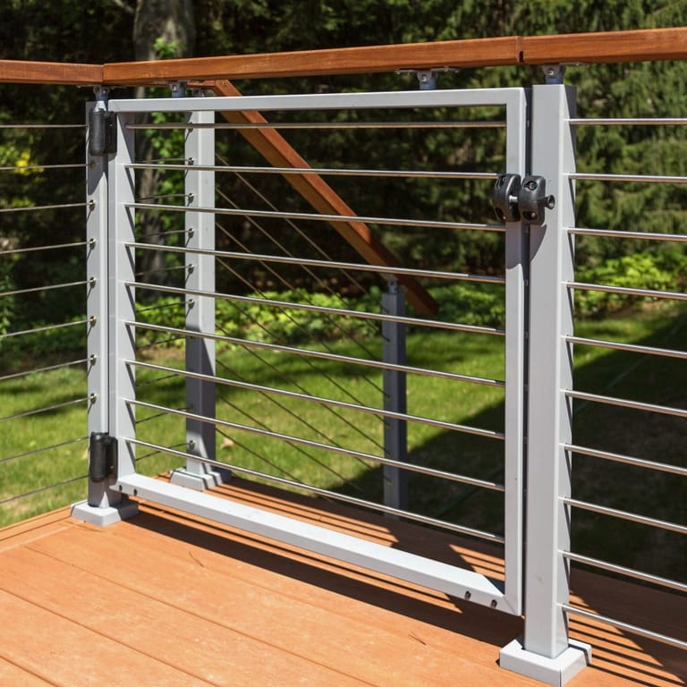 Stainless cable railing with wood top rail, painted aluminum frame, and integrated safety gate — Utah deck railing detail by CasaMás Construction